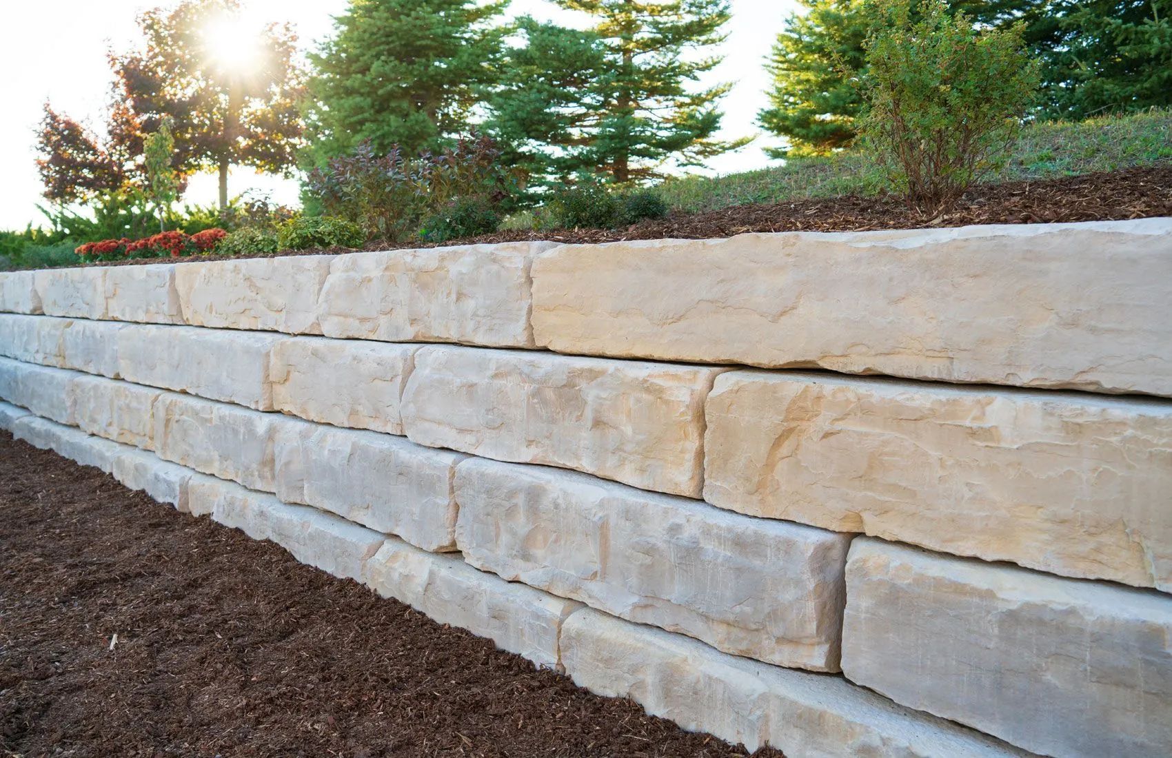 Grand Ledge large-format retaining wall in a planted landscape
